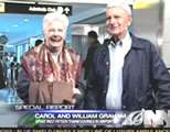 photo of happy older couple at airport; click to go to funny video page at external site; opens in new window