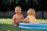 picture of two-year-olds in baby pool on lawn