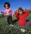 picture of girl playing in grass; link for environmental article, Chemical Pesticide Exposure and Effects on Children