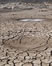 Global Warming Hoaxes and Conspiracies article link; thumb of picture of dry, cracked mud in barren area of Ethiopia