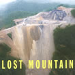 photo of a devastated mountain top, stripped bare to get to the coal