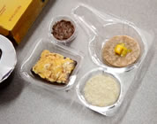 funny school lunch video link; thumb of upscale children's food in sectioned plastic container