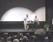 save the earth video link; thumb of photo of E O Wilson onstage with moderator