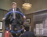 funny flying video link; thumb of man standing on desk with a hoop