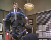 funny flying video link; thumb of man standing on desk with a hoop
