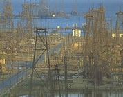 music videos about oil link; thumb of oil derricks on shore