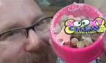 photo of a man with a toy bowl of edible dog food; click to see video on YouTube