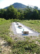 picture of four 2000-gallon cisterns in the ground